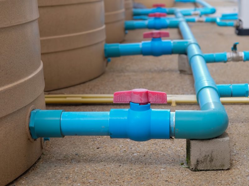 Blue water pipe installation from pump to tank.