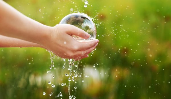 Conserving the environment is essential. Closeup shot of hands held out under a stream of water.
