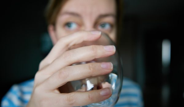 Woman drinks clean water from glass